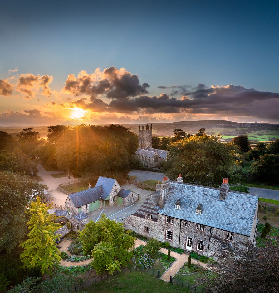 an aerial shot of the House that Emily Hobhouse used to live in. There is a sun setting in the background.
