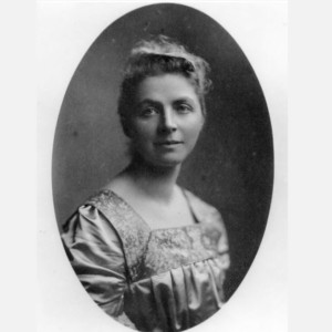 A black and white photograph of Emily Hobhouse. She is in her thirties and wearing an embroidered dress