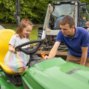 Children on tractor during the Summer of Play event at Lanhydrock, Cornwall