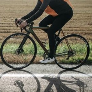 Photograph of a woman on a bike.