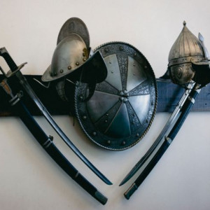 A photograph of swords, helmets and shields.